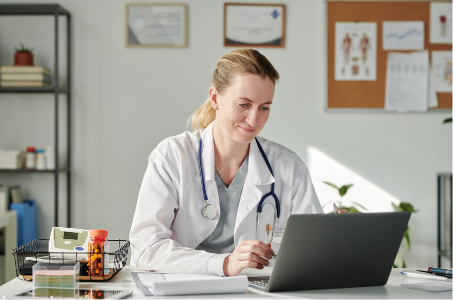 Clinician reviewing patient data on a laptop